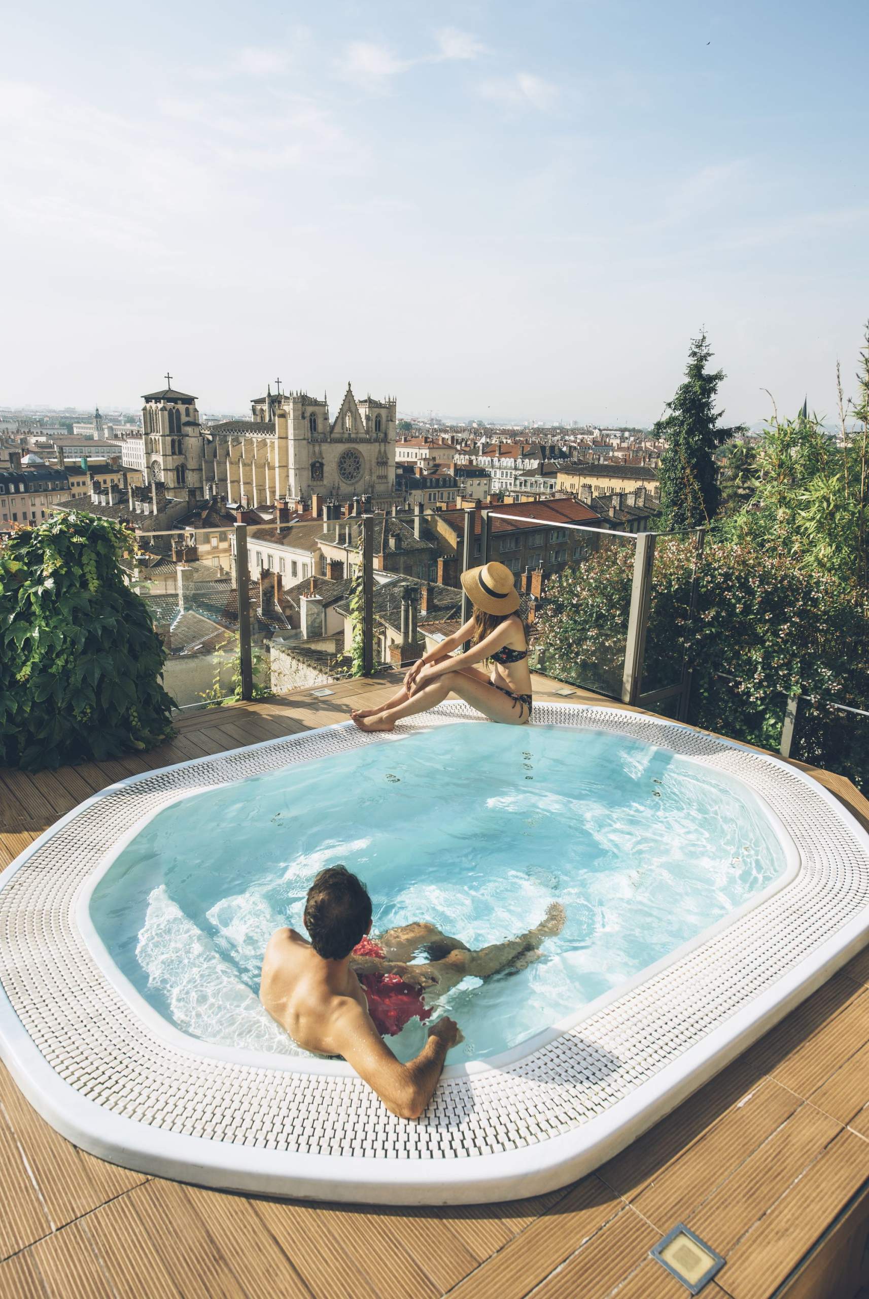 Outdoor swimming pool at La Villa Florentine with a view of Lyon